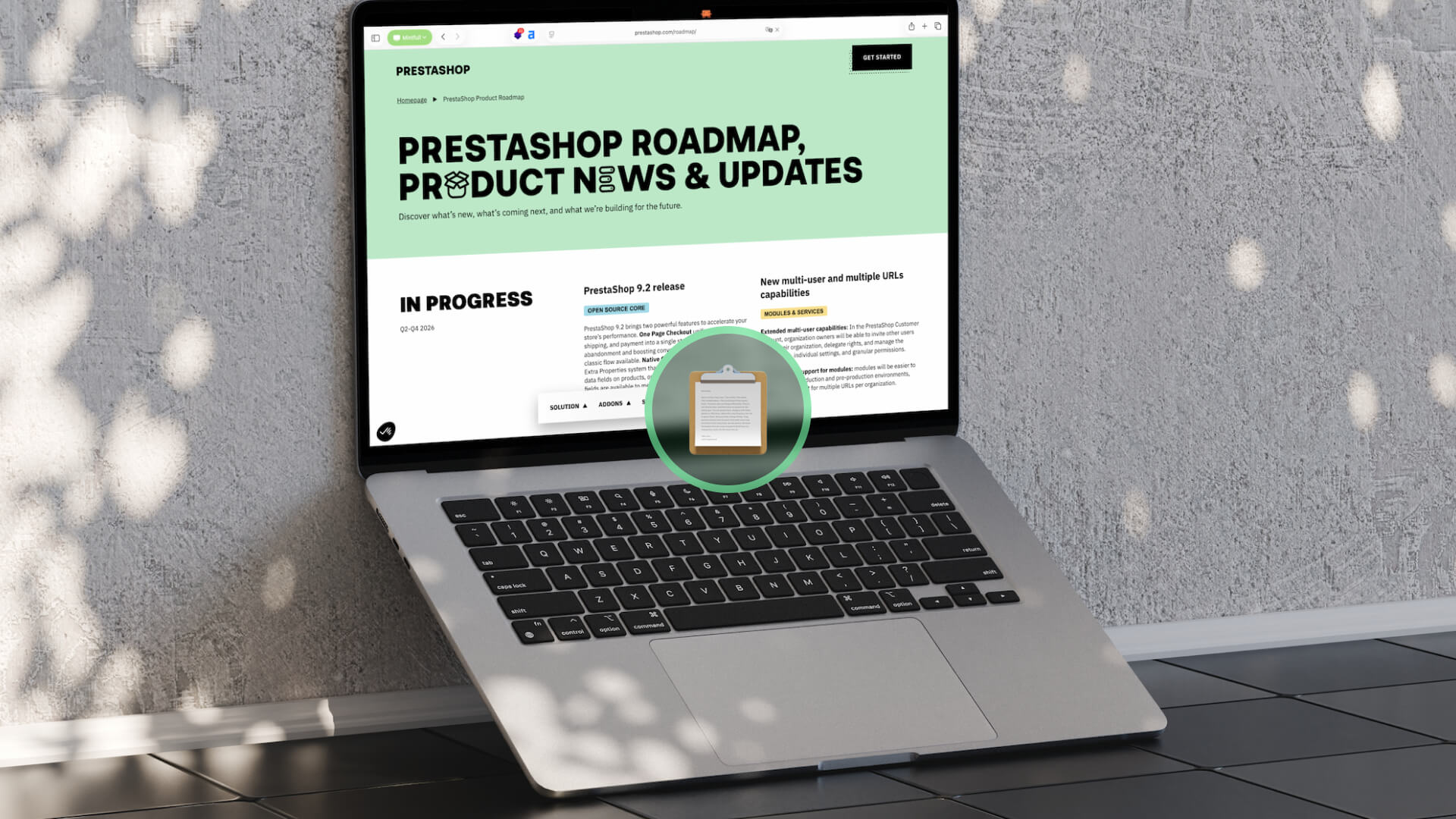 Laptop on a patio displaying a Prestashop roadmap webpage with a circular clipboard badge overlay